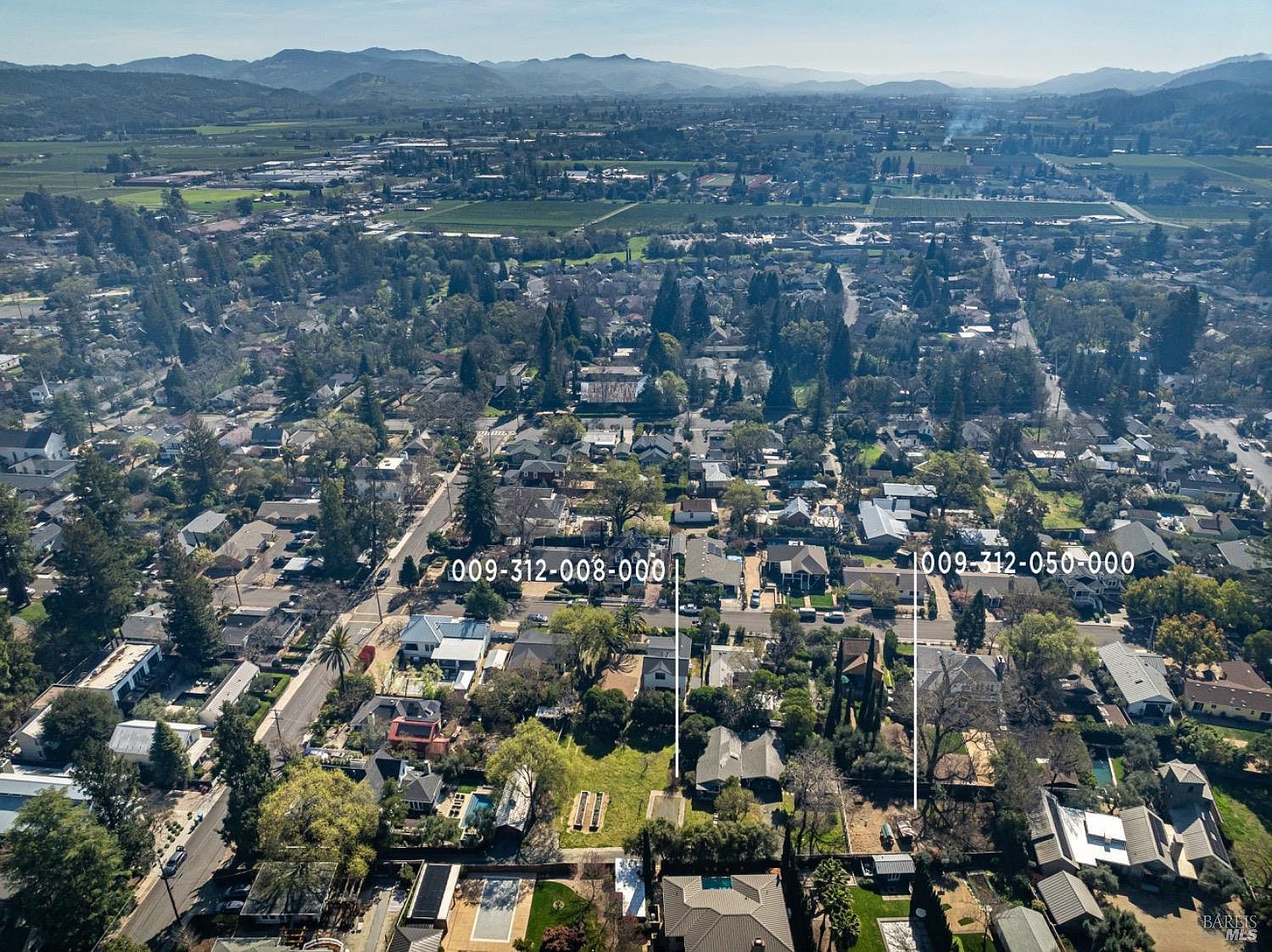 Aerial view showing the parcel set within Saint Helena's historic westside, with the Mayacamas and Vaca mountains beyond the valley.